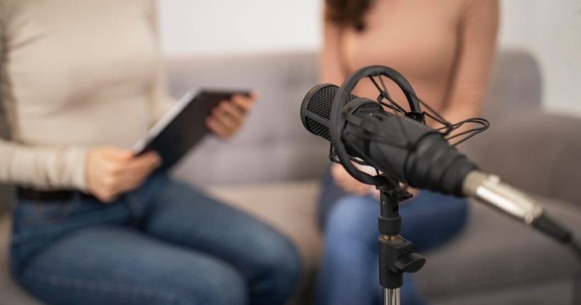 defocused-women-doing-radio-interview-with-microphone_23-2148808731