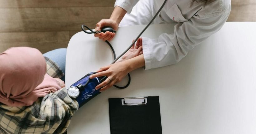 a doctor taking patient s blood pressure