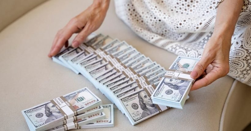 portrait-middle-aged-blonde-rich-woman-with-banknotes_23-2149668312